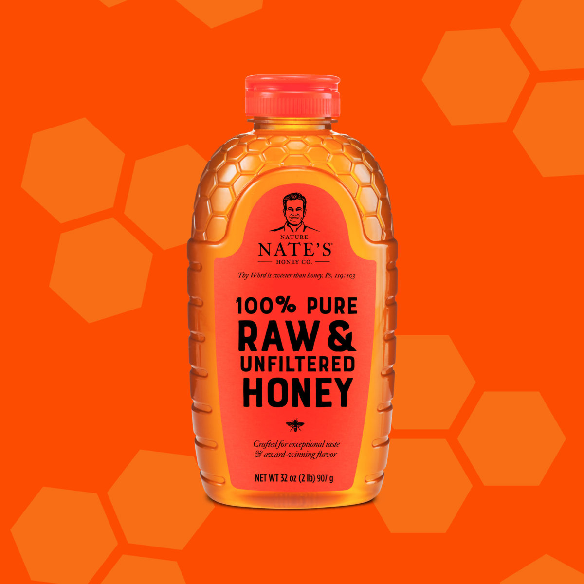 A bottle of Nate’s honey with an orange cap on a hexagonal honeycomb patterned background in orange hues.