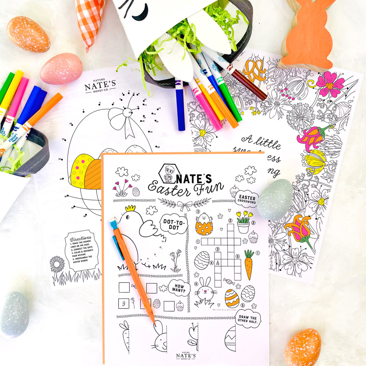 Colorful Easter activity sheets with markers, eggs, and a Nate's Easter Fun coloring sheet, sparking festive creativity.