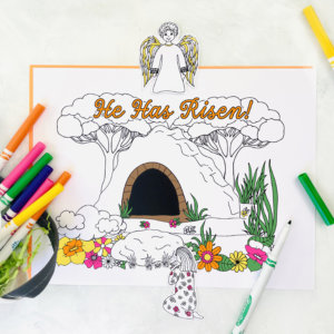An Easter coloring sheet with He Has Risen! text, Jesus Christ and flowers, accompanied by an array of colorful markers.