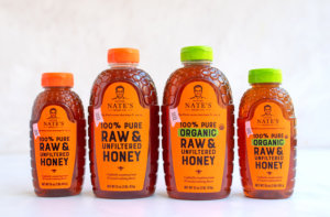Four bottles of Nature Nate's honey lined up against a white background, featuring varieties of pure, raw, and organic options. Four bottles of Nature Nate's honey lined up against a white background, featuring varieties of pure, raw, and organic options.