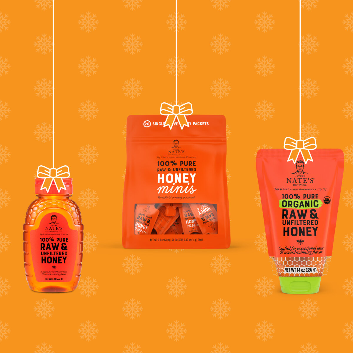 Three Nate’s honey products with bows, as if hanging ornaments, on an orange background with a floral pattern.