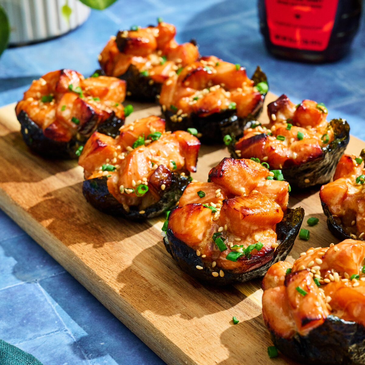 Salmon Sushi Cups with Hot Honey Mayo on wooden board.