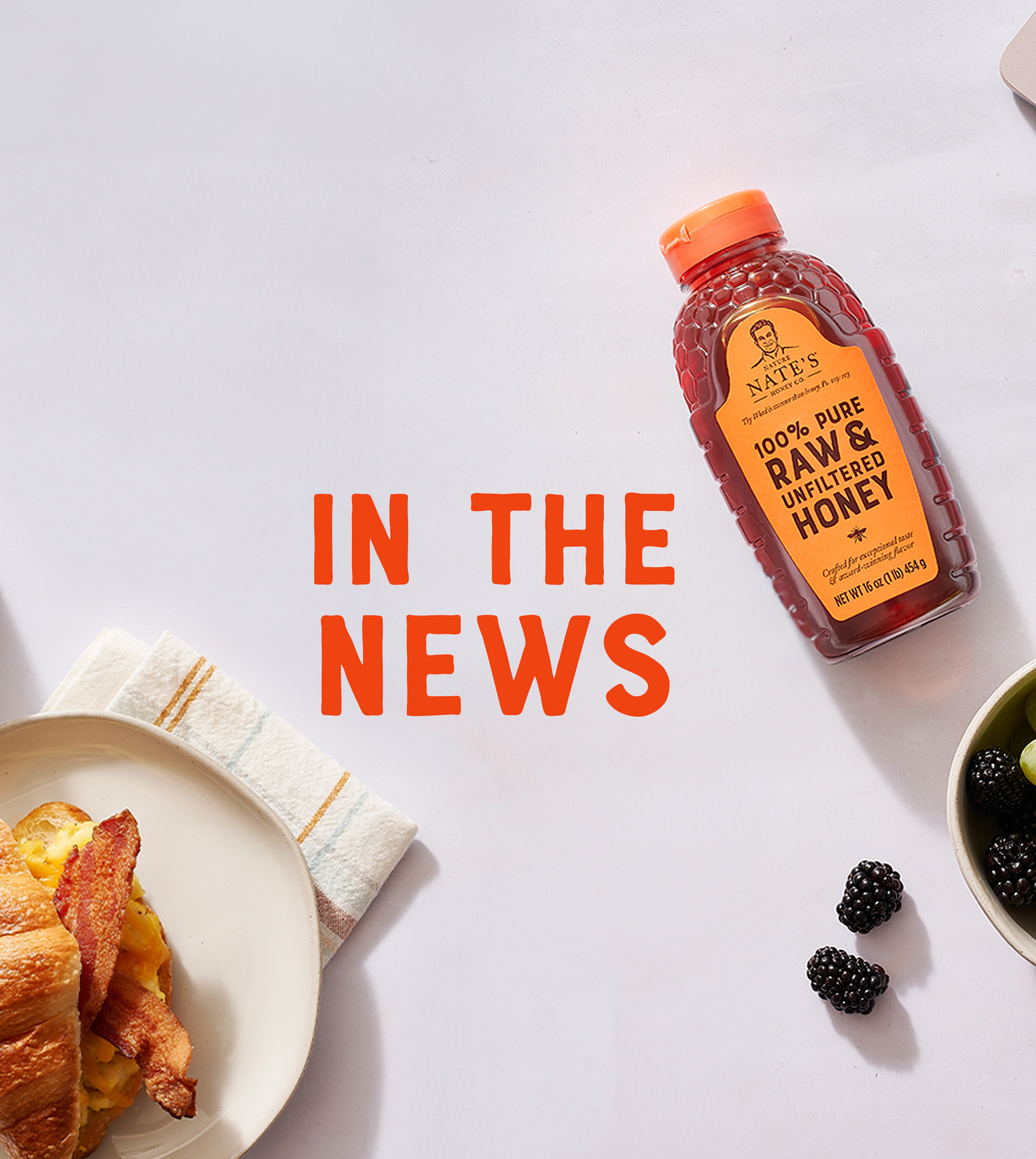Bottle of Nate's honey on white background with text "in the news"