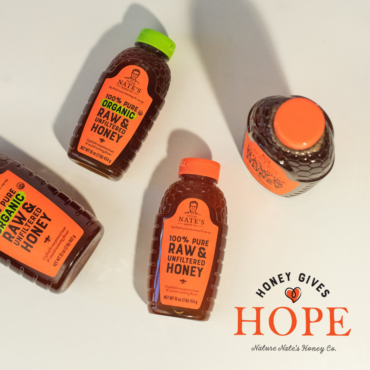 Two bottles of Nate’s honey and two bottles of Nate’s organic honey, with HONEY GIVES HOPE logo.