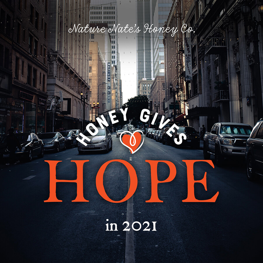 HONEY GIVES HOPE in 2021, on city street, with Nature Nate’s Honey Co text.