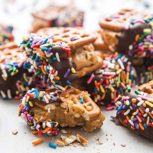Chocolate-dipped waffle pretzels with colorful sprinkles on top.