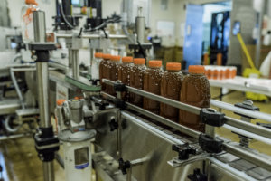 Nate's honey bottles on a production line in a bottling plant.